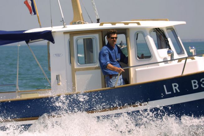 Bertrand Danglade, founder of Rha Marine, at the helm of one of his boats in 2001
