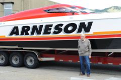 Howard Arneson in front of an offshore racing boat at his 96th birthday