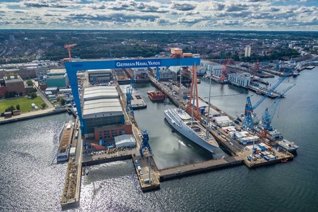 Aerial view of one of the shipyards of Nobiskrug, with a superyacht in armament